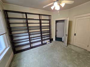 Garage with a ceiling fan and baseboards