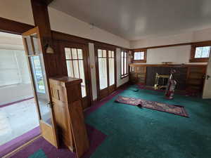 Living room with a brick fireplace and carpet flooring