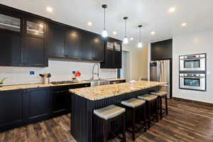 Kitchen features granite countertops, Bosch double ovens, gas range, huge island, and a walk-in pantry