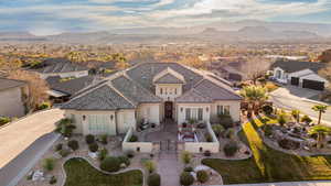 View of front of property featuring a gate, stucco siding, a residential view, and a fenced front yard