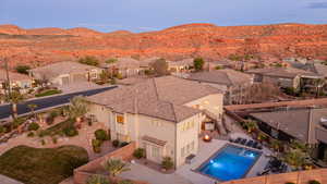 Aerial perspective of suburban area featuring a pool and a mountain backdrop