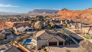 Aerial perspective of suburban area featuring a mountainous background