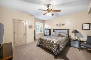 Bedroom featuring carpet flooring, a ceiling fan, and a textured ceiling