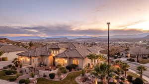 Mediterranean / spanish house featuring stucco siding, a mountain view, a tile roof, a residential view, and a patio area
