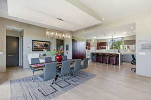 Dining space with light wood-style flooring and hanging lights