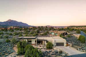 View of front of property featuring a mountain view, stucco siding, and driveway