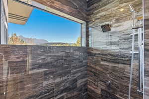 Bathroom featuring tiled shower and a mountain view