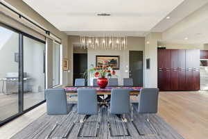 Dining space with light wood-type flooring and recessed lighting