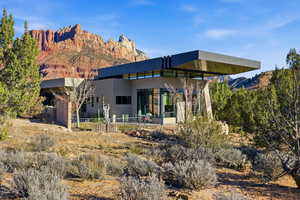 Back of property with a patio, a mountain view, and stucco siding