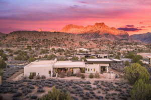 View of front of property featuring a mountain view, stucco siding, and a desert view