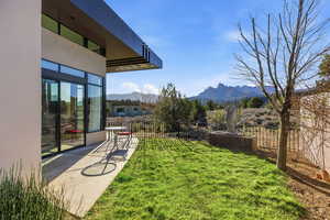 Fenced backyard featuring a mountain view and a balcony