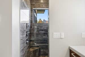 Full bath featuring walk in shower and vanity