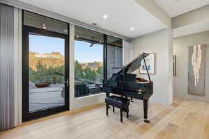Living area featuring light wood-style floors, a mountain view, and recessed lighting