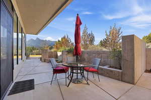 Fenced backyard featuring a patio, outdoor dining space, and a mountain view