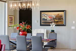Dining space featuring a chandelier and light wood finished floors