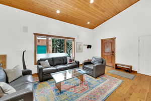 Living room with recessed lighting, wood finished floors, and a vaulted wood ceiling