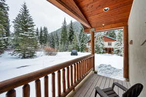 Snow covered deck featuring a porch