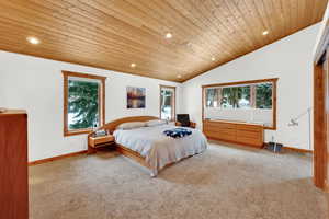 Carpeted bedroom featuring a vaulted wooden ceiling and recessed lighting