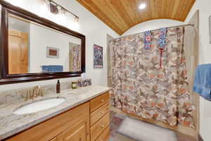 Full bath with vanity, wooden ceiling, recessed lighting, and a barrel ceiling