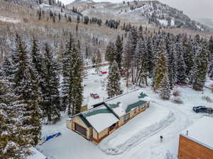Aerial view of property and surrounding area with a mountain backdrop