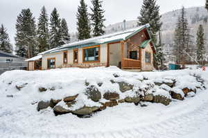 View of front of house featuring stone siding and stucco siding