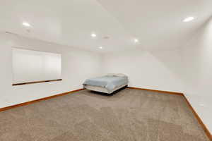 Bedroom with recessed lighting and light colored carpet