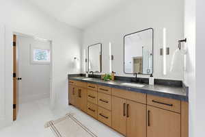 Bathroom with double vanity and a shower stall