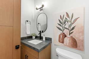 Half bath with vanity and toilet