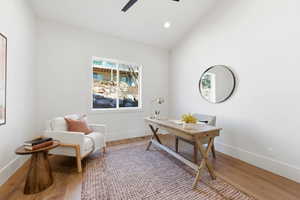 Office space featuring lofted ceiling, wood finished floors, recessed lighting, and a ceiling fan