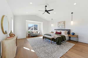 Bedroom featuring light wood-style floors, a ceiling fan, lofted ceiling, and recessed lighting