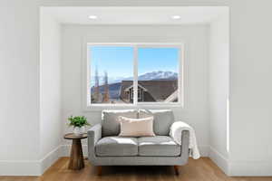 Sitting room with wood finished floors, recessed lighting, and a mountain view