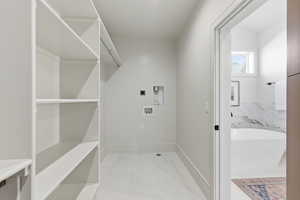 Laundry area featuring hookup for a washing machine and baseboards