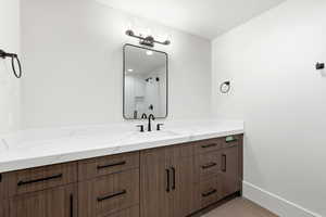 Bathroom featuring light tile patterned floors and vanity