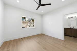 Unfurnished bedroom with light wood-style flooring, ceiling fan, connected bathroom, and recessed lighting