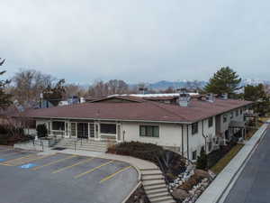 View of property with a mountain view and uncovered parking