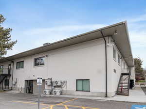 Rear view of house featuring stairs and brick siding