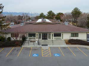 View of building exterior with uncovered parking and a mountain view