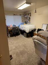 Carpeted bedroom featuring a textured ceiling