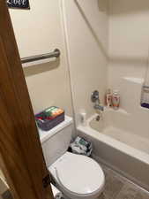 Full bath with tub / shower combination and tile patterned floors