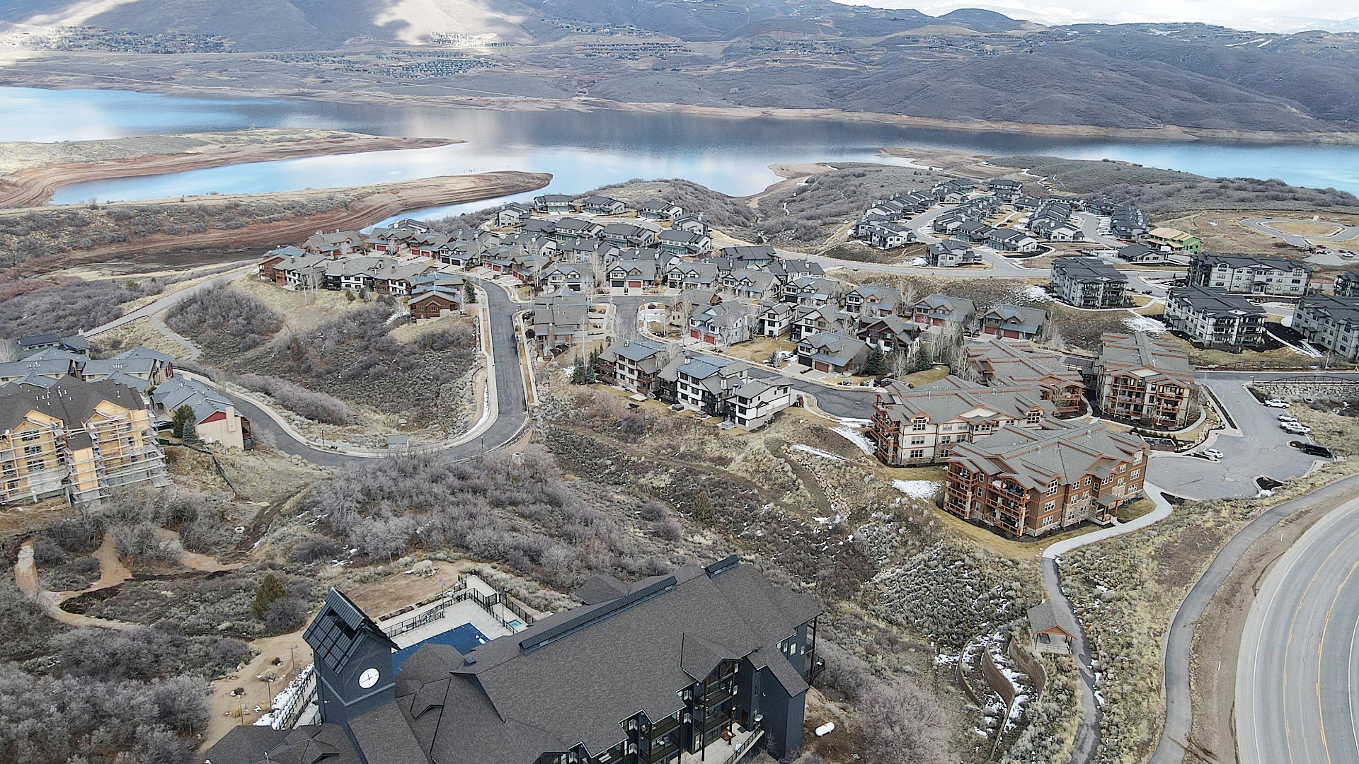 View of property location with a water and mountain view and nearby suburban area