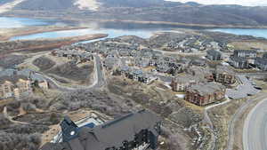 View of property location with a water and mountain view and nearby suburban area