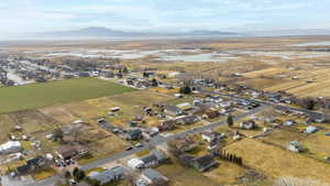 Overview of rural landscape with a mountain backdrop and nearby suburban area