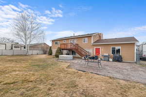 Rear view of property featuring stairs and a patio area