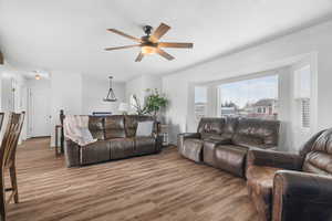 Living room with LVP floors and a ceiling fan