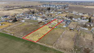 Aerial view from the back with property parcel outlined and nearby suburban area