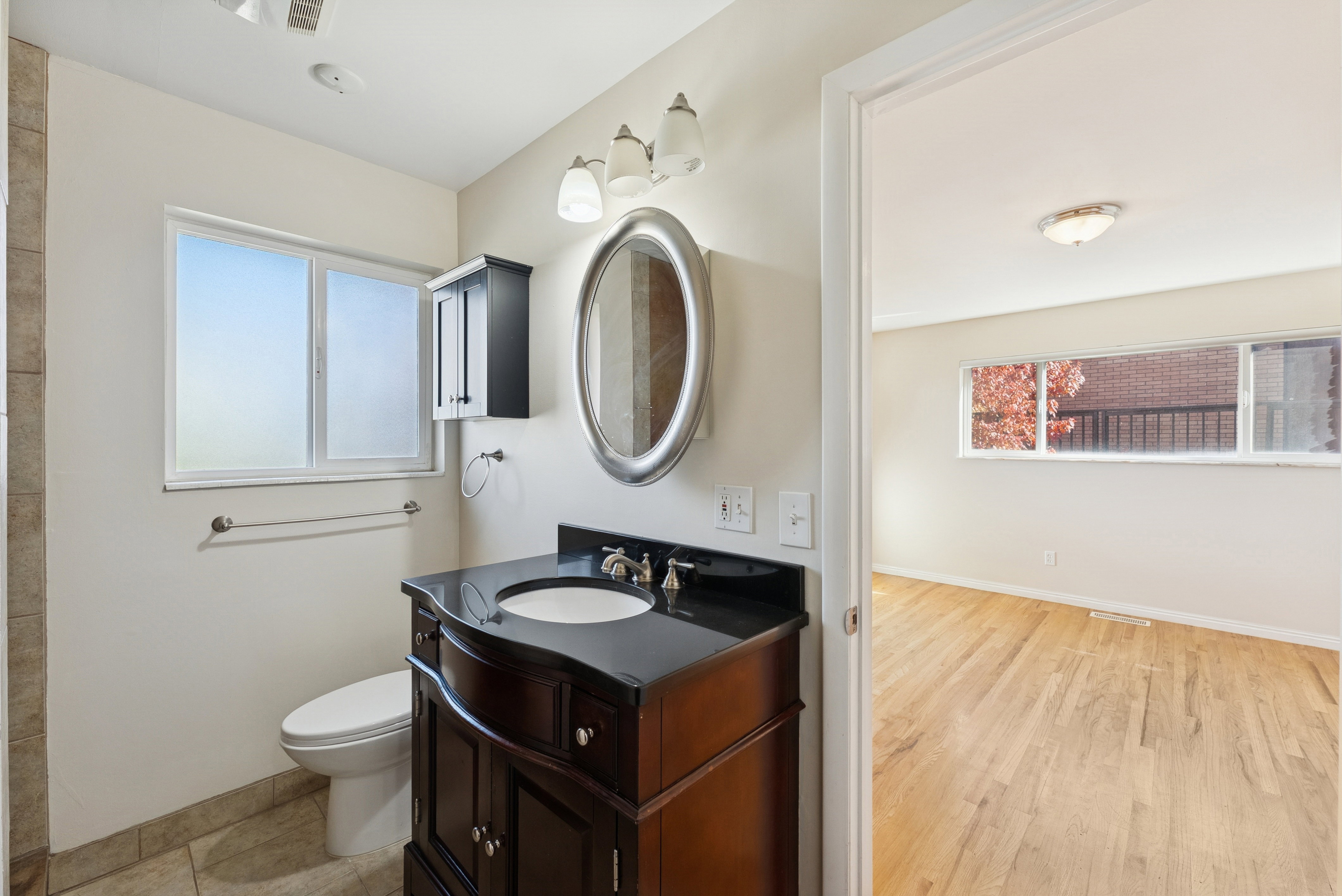 Bathroom with vanity and light wood-type flooring