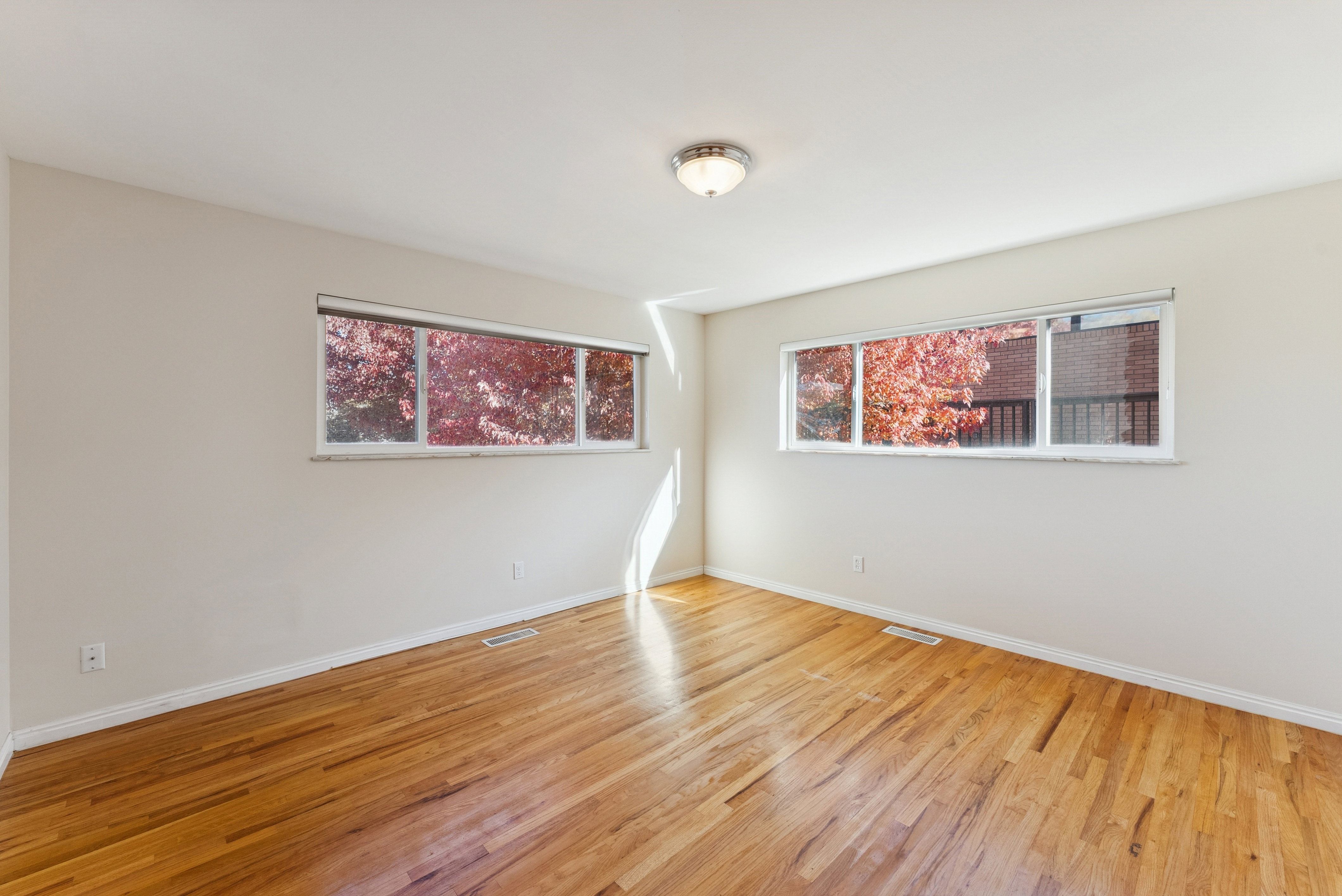 Unfurnished room featuring light wood-style flooring and baseboards