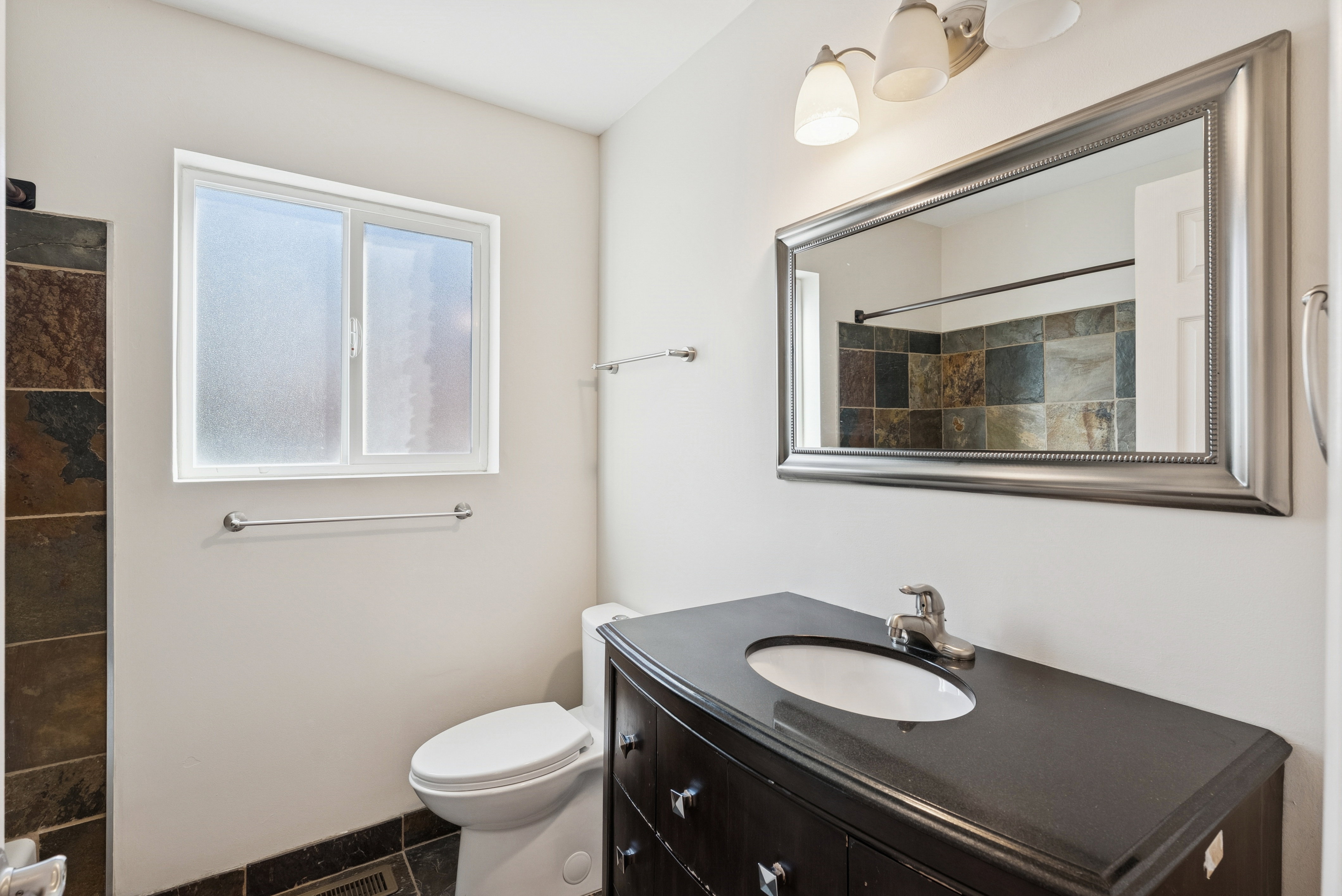 Full bathroom with vanity and a shower