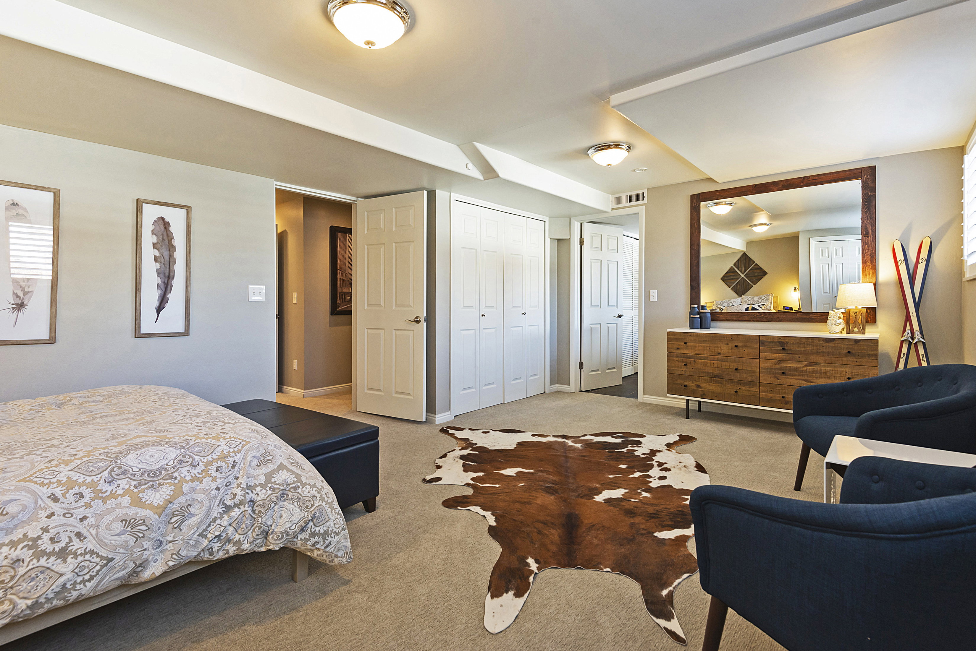Bedroom featuring carpet flooring and two closets