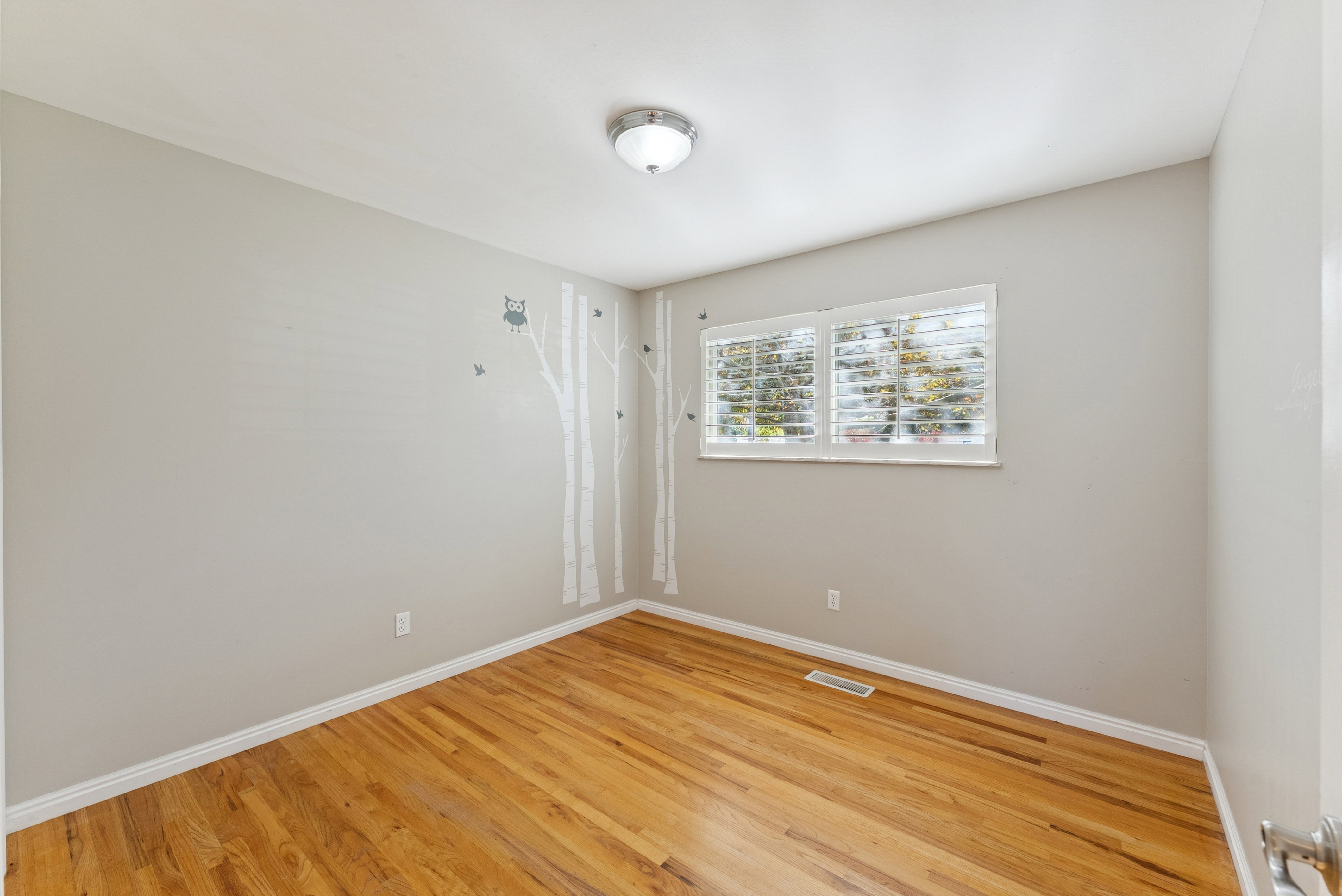 Empty room featuring wood finished floors and baseboards